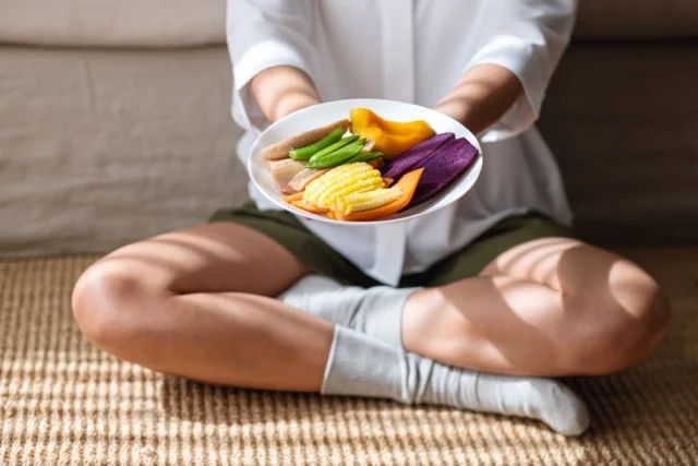 Woman eating vegetables